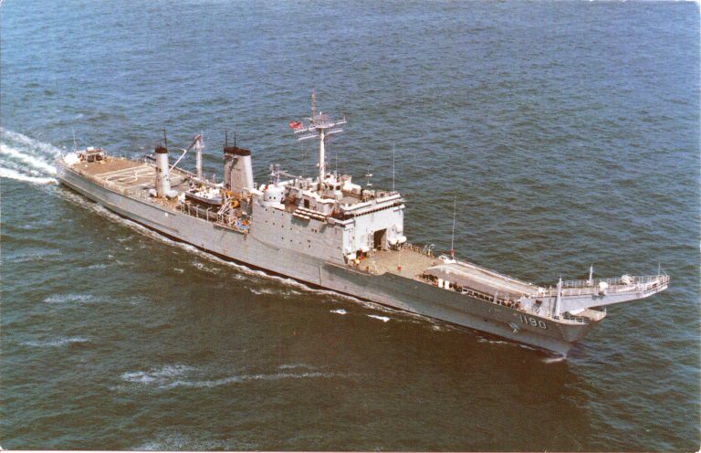 Postcard photo of USS Boulder underway, with visible rust along the hull